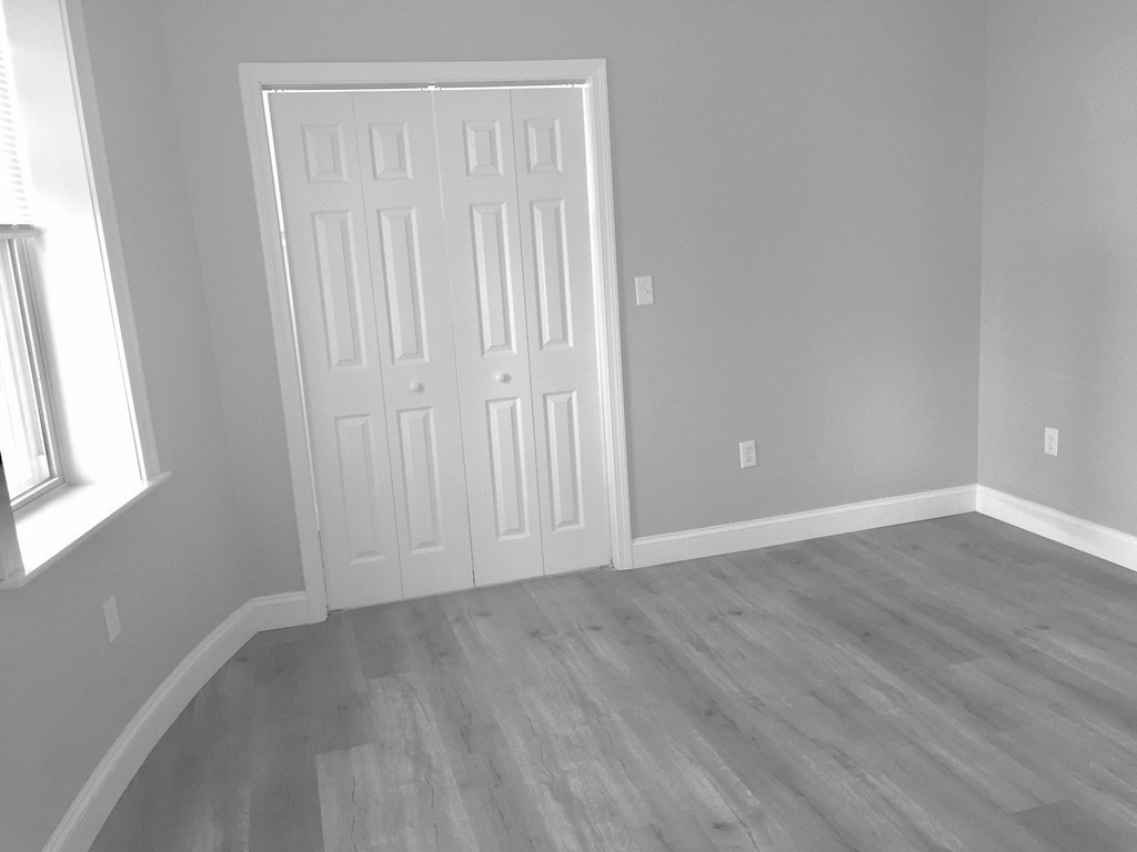 7 Leicester Street, Unit 2 Boston, MA 02135 - Photo 8 of 9 a view of an empty room with wooden floor and a window