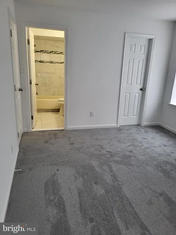 a picture of a bathroom with a white wall and a white kitchen with a sink