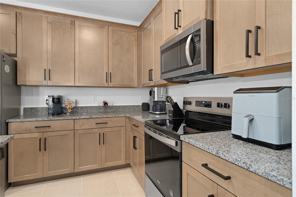 655 Clark Street Oviedo, FL 32765 - Photo 11 of 44 a kitchen with stainless steel appliances granite countertop a sink and cabinets