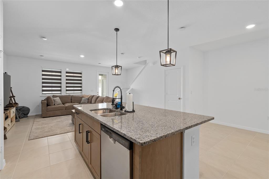 655 Clark Street Oviedo, FL 32765 - Photo 12 of 44 a kitchen with living room and chandelier