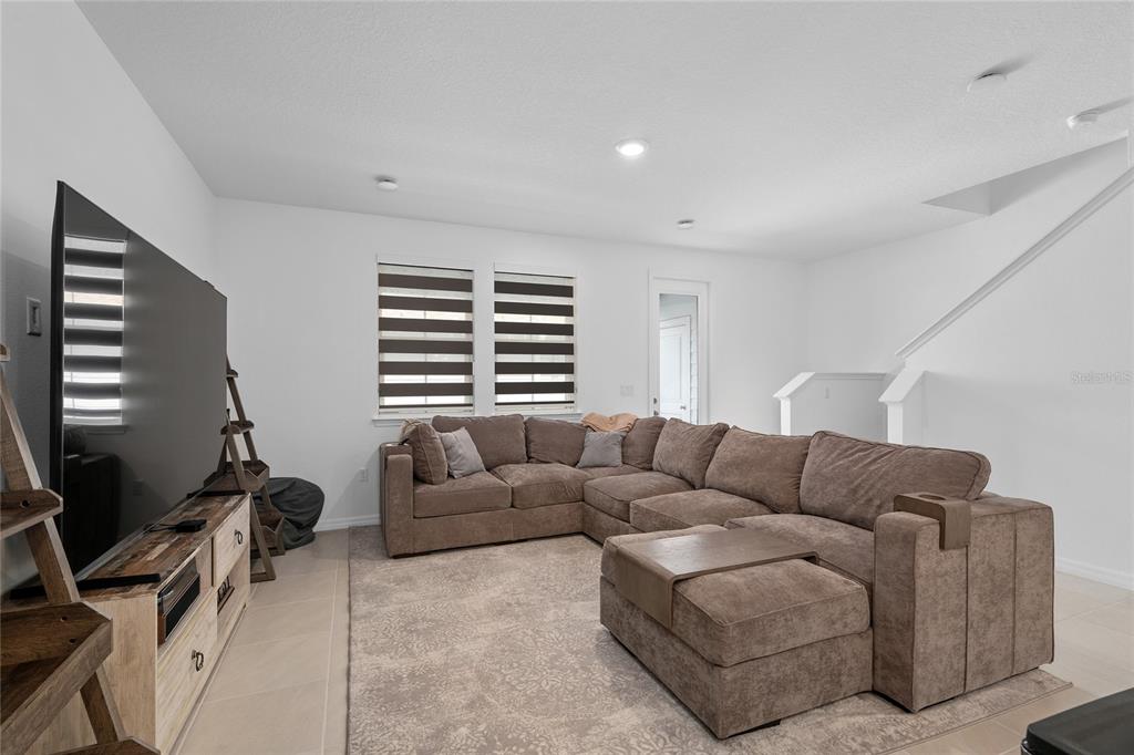 655 Clark Street Oviedo, FL 32765 - Photo 13 of 44 a living room with furniture a couch and a flat screen tv