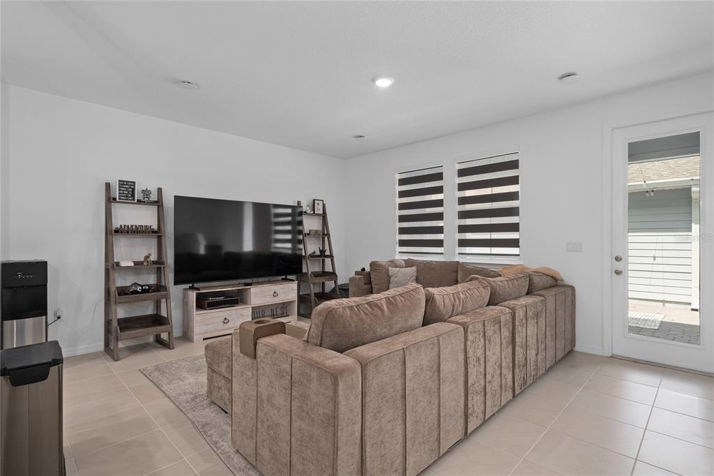 655 Clark Street Oviedo, FL 32765 - Photo 14 of 44 a living room with furniture and a flat screen tv