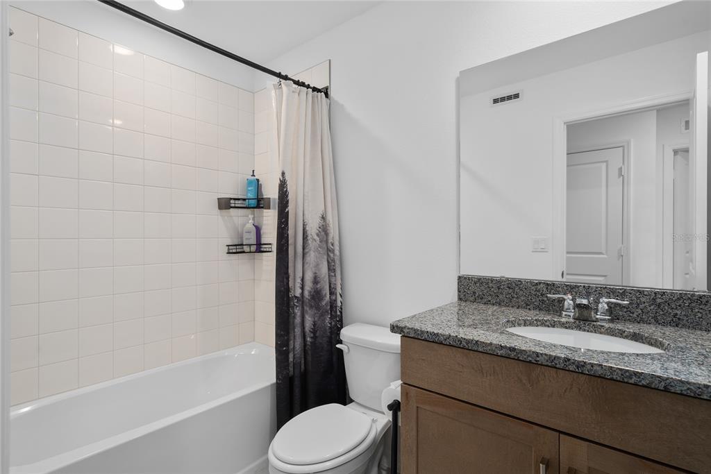 655 Clark Street Oviedo, FL 32765 - Photo 17 of 44 a bathroom with a granite countertop sink toilet and shower