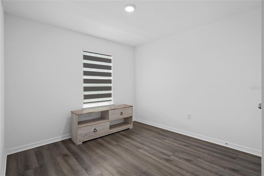 655 Clark Street Oviedo, FL 32765 - Photo 18 of 44 an empty room with wooden floor and window