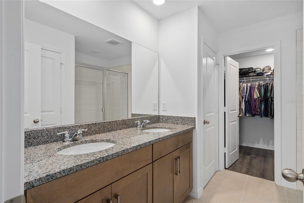 655 Clark Street Oviedo, FL 32765 - Photo 20 of 44 a bathroom with a granite countertop sink and a mirror