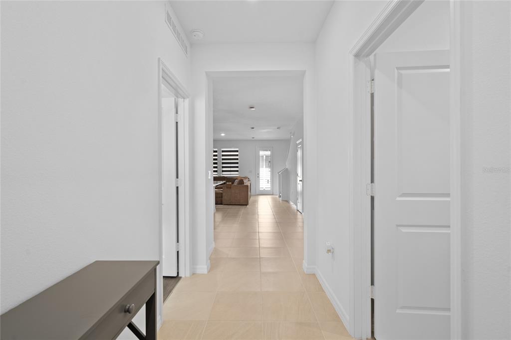 655 Clark Street Oviedo, FL 32765 - Photo 2 of 44 a view of a hallway with dining room and wooden floor