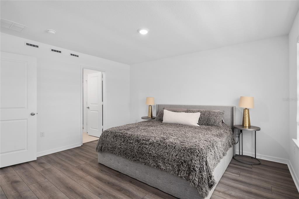 655 Clark Street Oviedo, FL 32765 - Photo 22 of 44 a bedroom with a bed and wooden floor