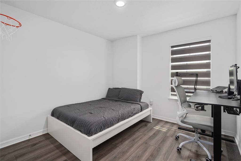 655 Clark Street Oviedo, FL 32765 - Photo 25 of 44 a bedroom with a bed and a desk