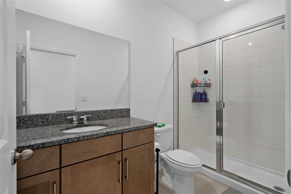 655 Clark Street Oviedo, FL 32765 - Photo 3 of 44 a bathroom with a granite countertop sink toilet and shower