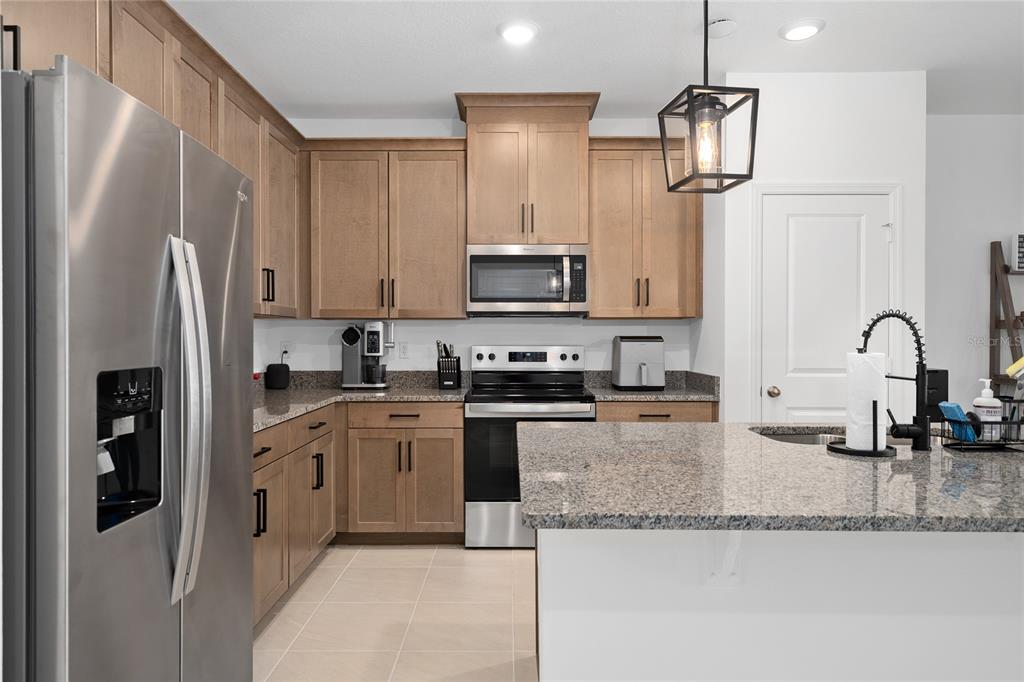 655 Clark Street Oviedo, FL 32765 - Photo 8 of 44 a kitchen with stainless steel appliances granite countertop a refrigerator a stove a sink and a granite counter tops