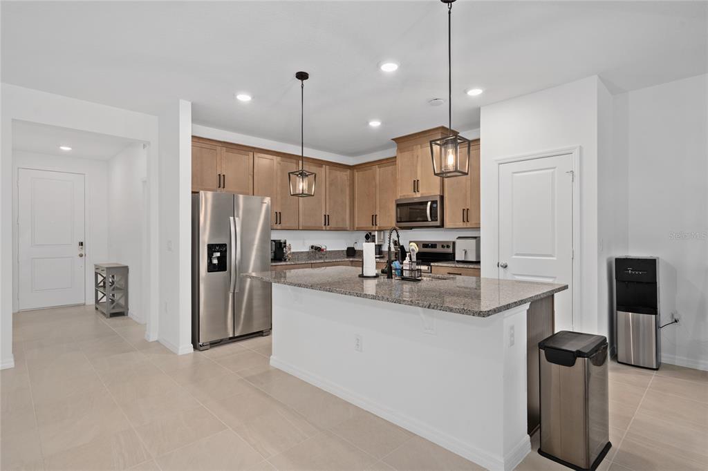 655 Clark Street Oviedo, FL 32765 - Photo 9 of 44 a kitchen with refrigerator and chairs