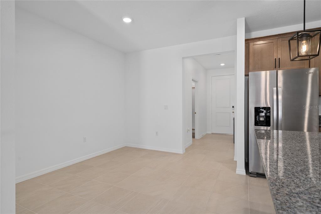655 Clark Street Oviedo, FL 32765 - Photo 10 of 44 a view of a kitchen with a refrigerator and a fireplace