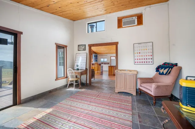 a view of a house with wooden deck and furniture