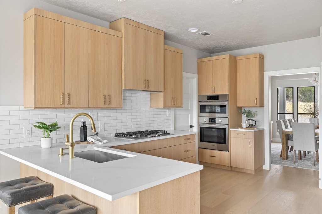6311 Rusty Ridge Drive Austin, TX 78731 - Photo 12 of 37 a kitchen with a refrigerator sink and white cabinets