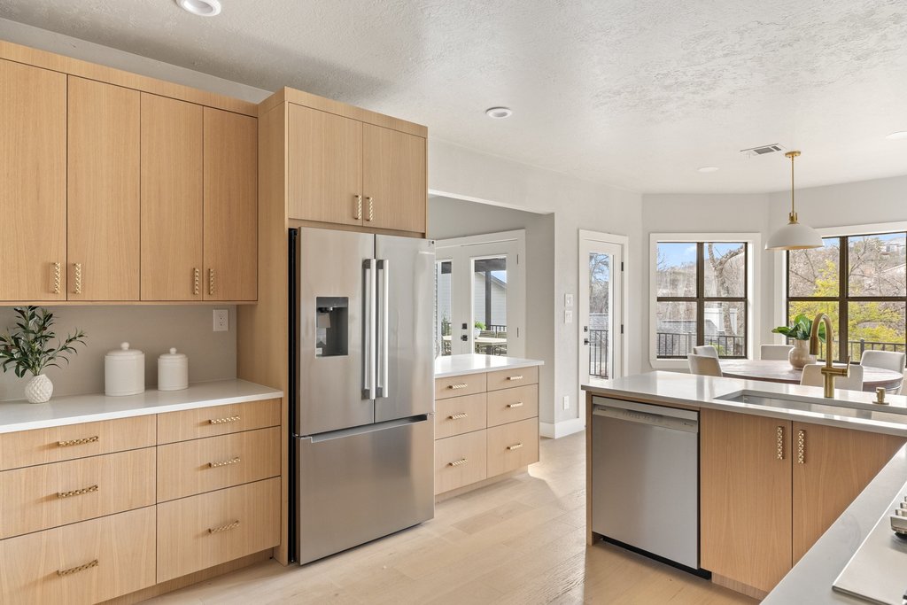 6311 Rusty Ridge Drive Austin, TX 78731 - Photo 15 of 37 a kitchen with white cabinets and white appliances