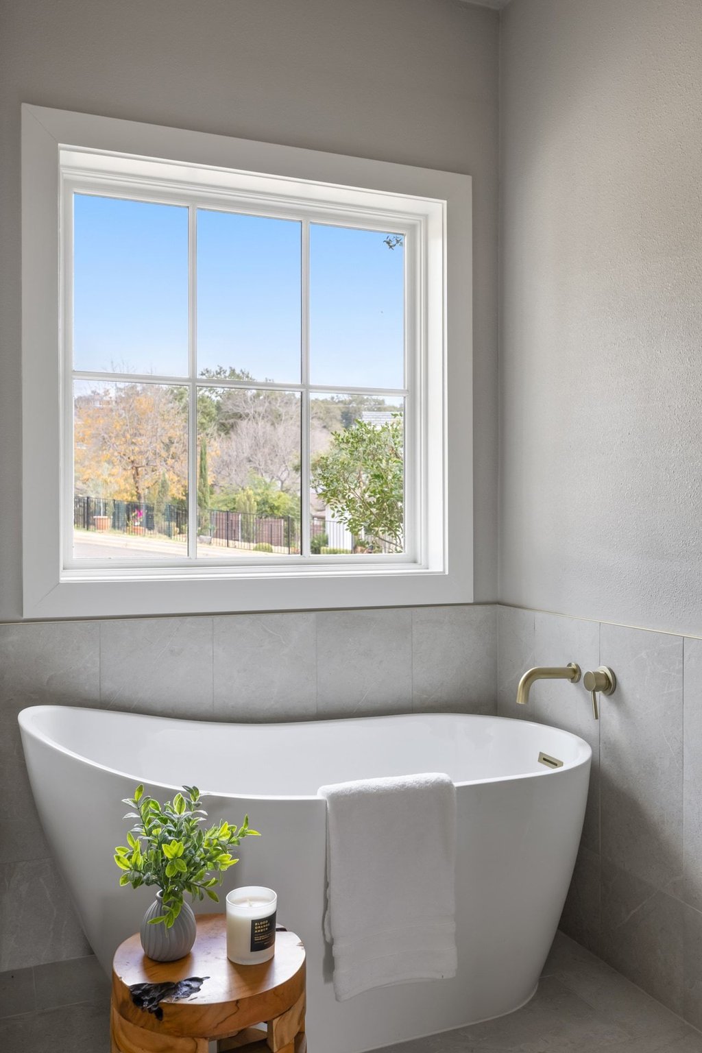 6311 Rusty Ridge Drive Austin, TX 78731 - Photo 23 of 37 a white bath tub sitting in a bathroom next to a window