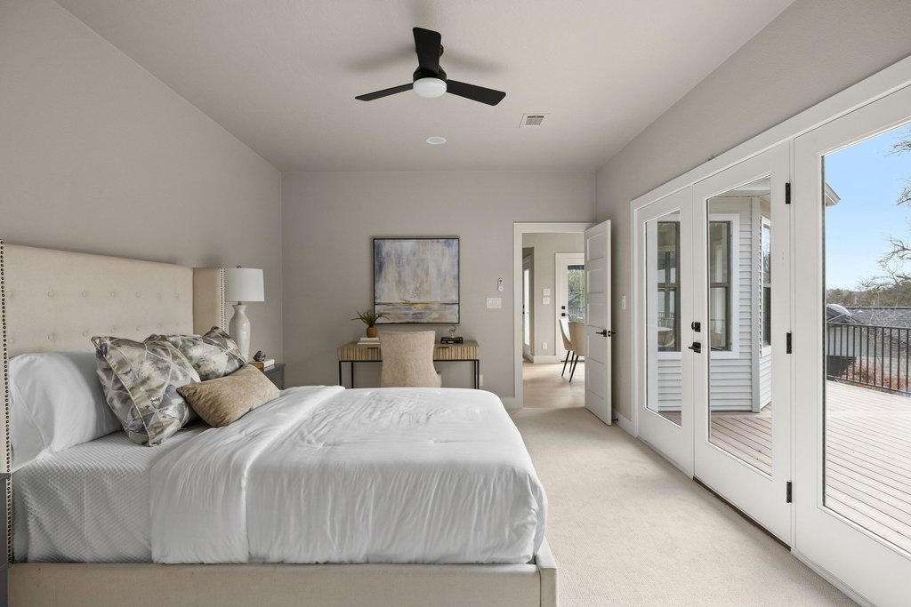 6311 Rusty Ridge Drive Austin, TX 78731 - Photo 24 of 37 a bedroom with a large bed and a chandelier