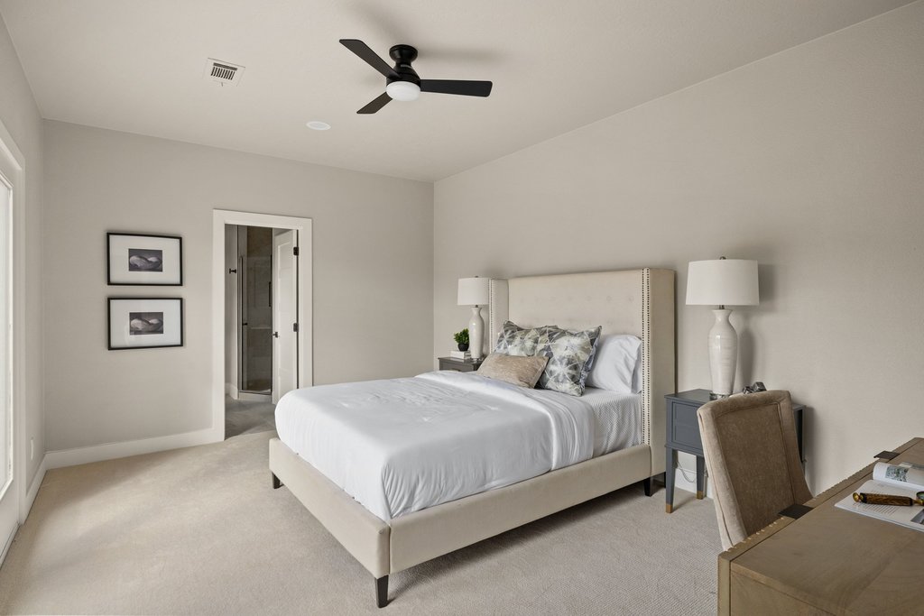 6311 Rusty Ridge Drive Austin, TX 78731 - Photo 25 of 37 a bedroom with a bed a couch and a lamp on the dresser