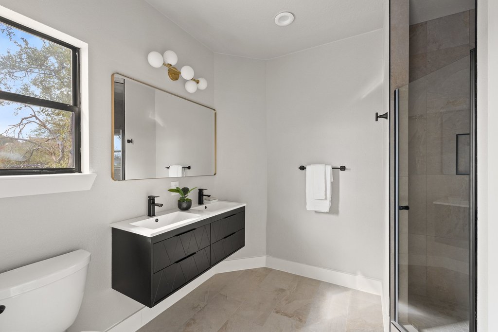 6311 Rusty Ridge Drive Austin, TX 78731 - Photo 27 of 37 a bathroom with a toilet sink and mirror