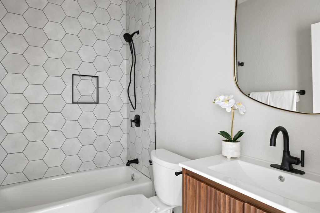 6311 Rusty Ridge Drive Austin, TX 78731 - Photo 29 of 37 a bathroom with a sink a toilet and a shower