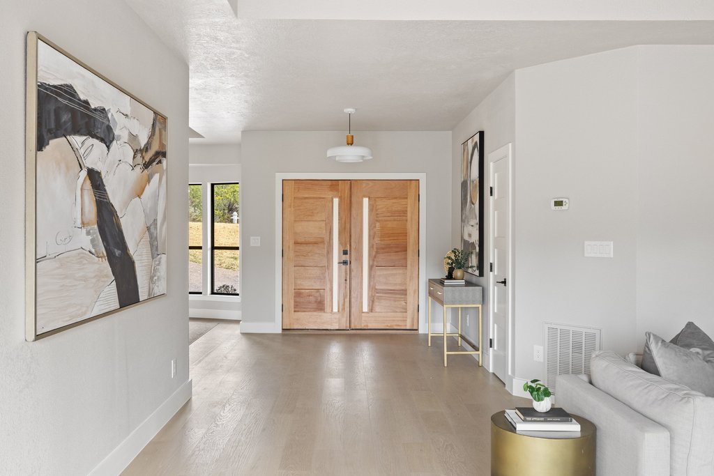 6311 Rusty Ridge Drive Austin, TX 78731 - Photo 3 of 37 a hallway with a wooden floor and a dining table