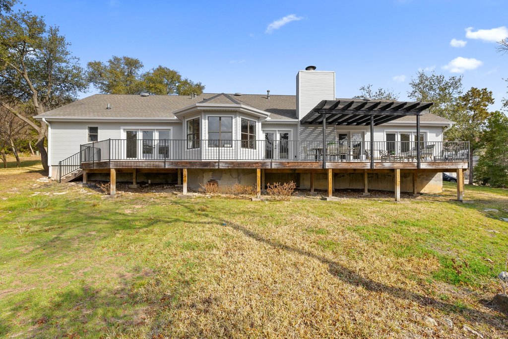 6311 Rusty Ridge Drive Austin, TX 78731 - Photo 35 of 37 a front view of a house with a yard table and chairs
