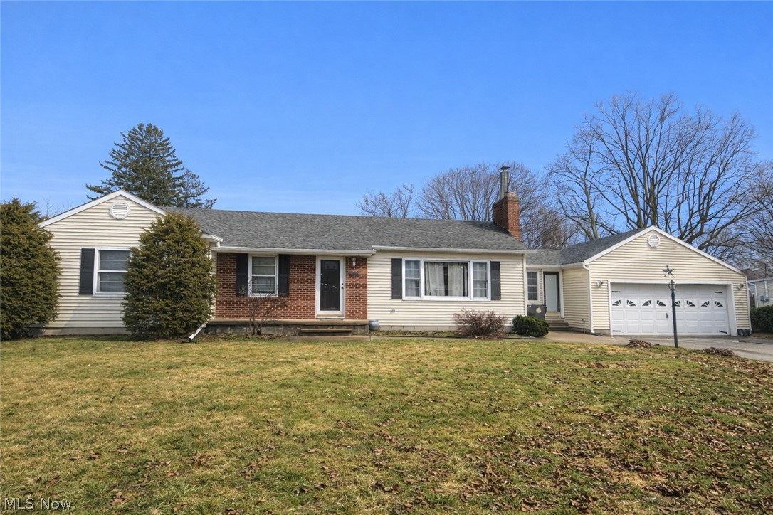 3828 Lake Road West Ashtabula, OH 44004 - Photo 2 of 29 Single story home featuring a garage, a front lawn, a chimney, driveway, and entry steps