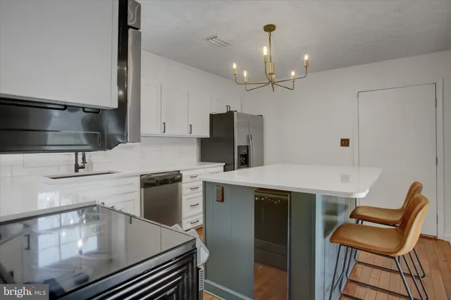 a kitchen with a table chairs stove and microwave
