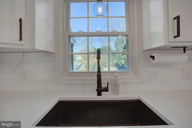a bathroom with a sink and a window