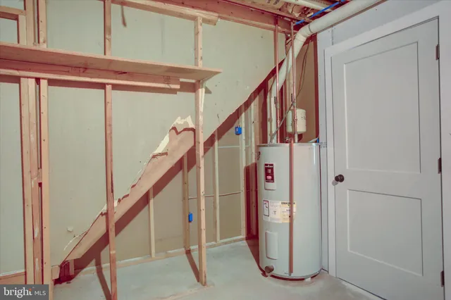 a view of a backyard with table and chairs potted plants and large tree