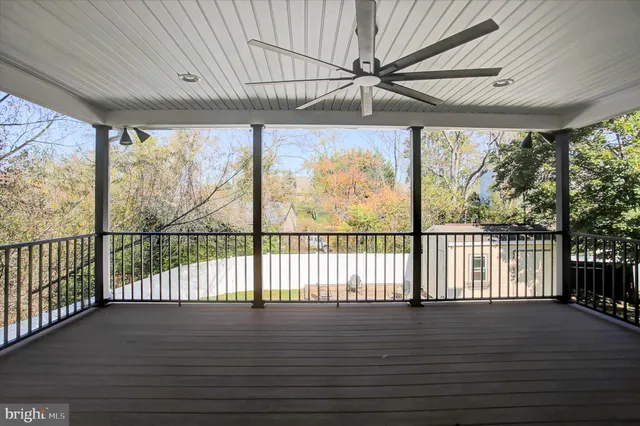 a view of a big house with a big yard and large trees
