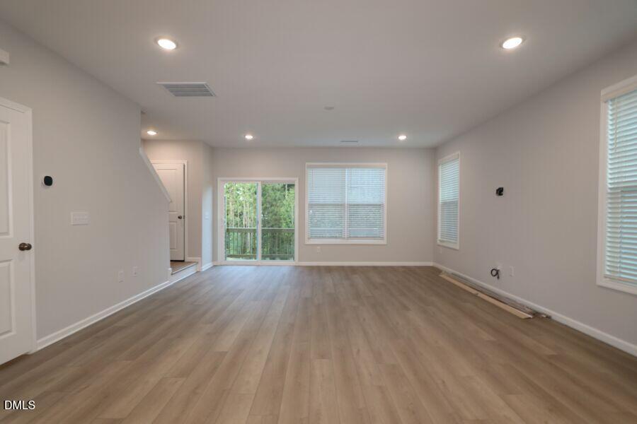 2913 Richardson Road, Unit 475 Apex, NC 27502 - Photo 6 of 24 an empty room with wooden floor and windows