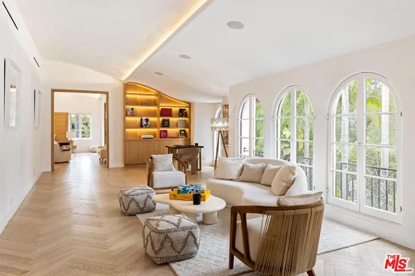 a view of a patio with table and chairs potted plants and large tree