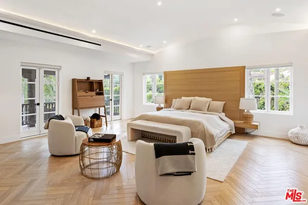 a backyard of a house with barbeque oven table and chairs
