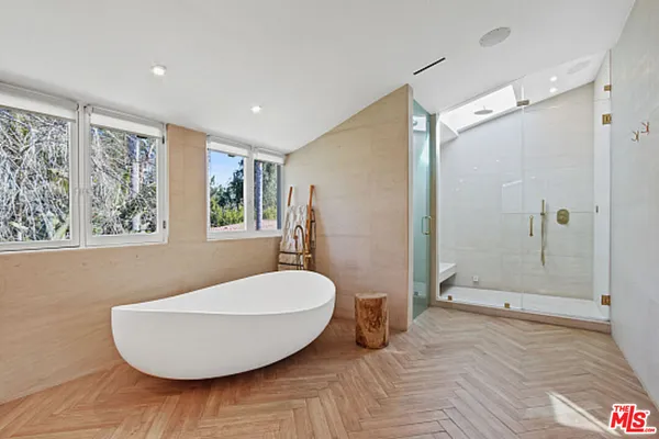 a large bedroom with a bed and a large mirror