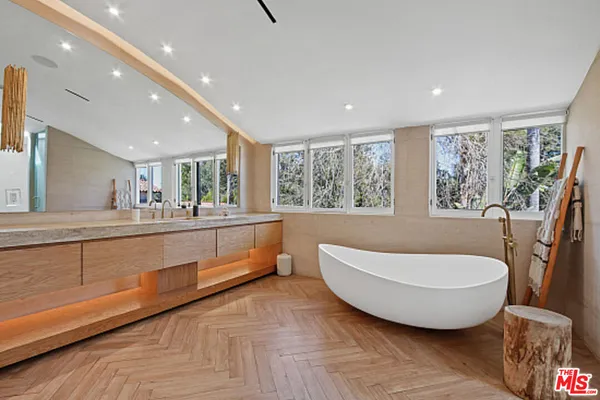 a bathroom with a sink a mirror and a shower