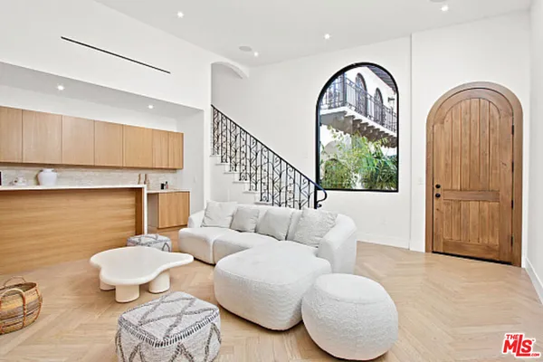 a bedroom with a bed and large window