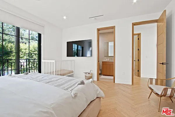 a bedroom with a bed and a night stand