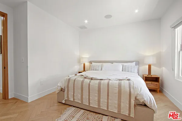 a view of a patio with table and chairs potted plants and a large tree