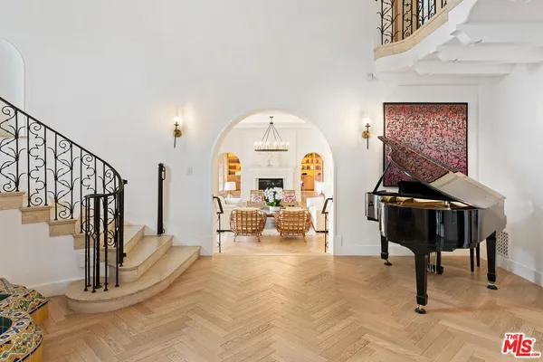 a living room with furniture a rug and white walls