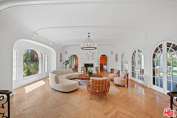 a living room with furniture and a floor to ceiling window