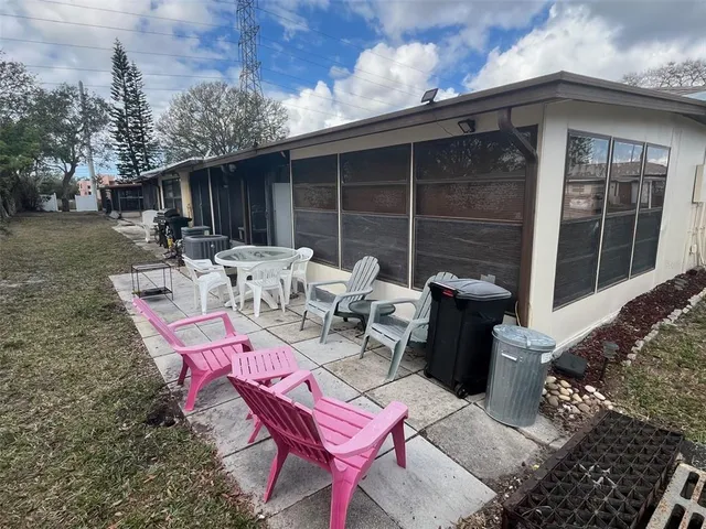 a view of a patio with couple of chairs and couches