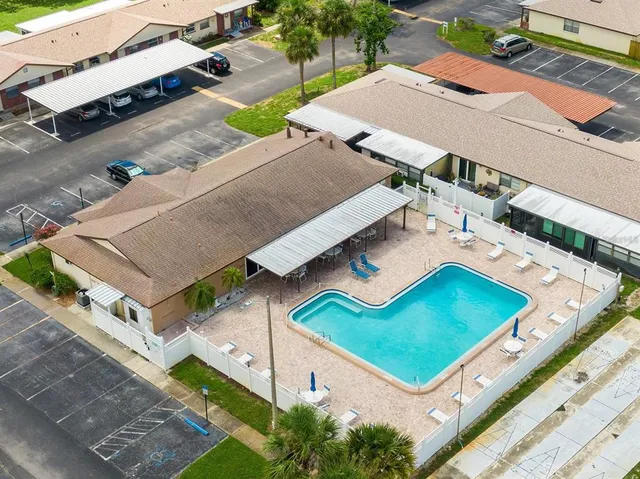 an aerial view of a house with a backyard