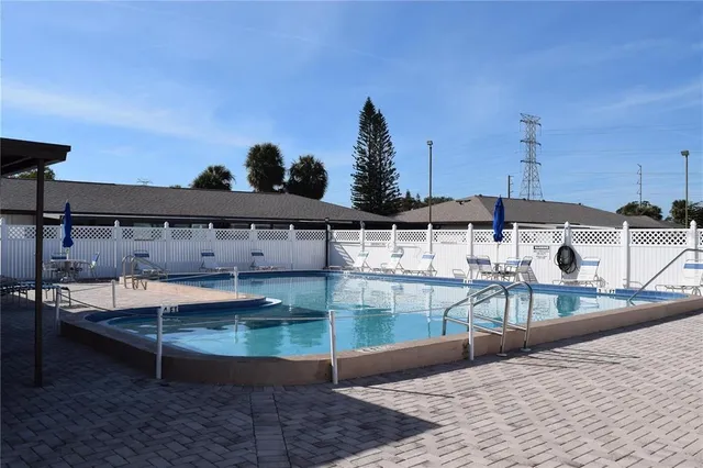 a view of a swimming pool with a lounge chairs