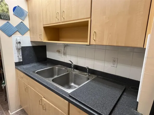 a kitchen with a sink and cabinets