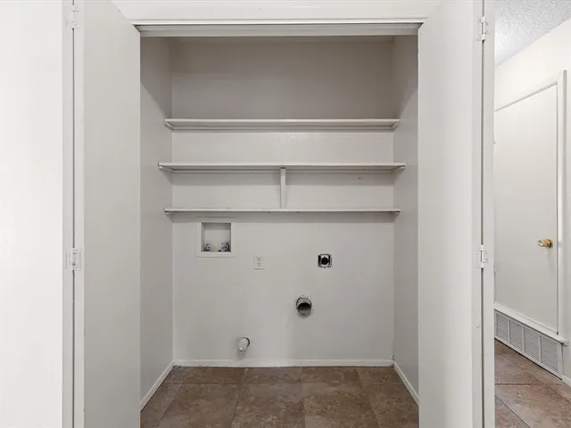 a view of an empty room with a ceiling fan