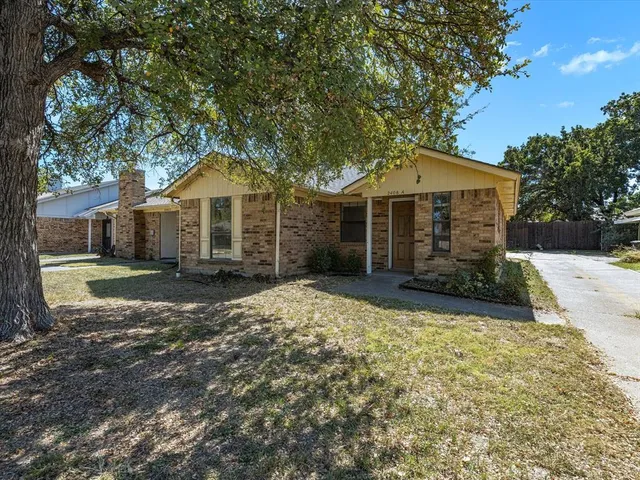 a front view of a house with a yard garage and outdoor seating