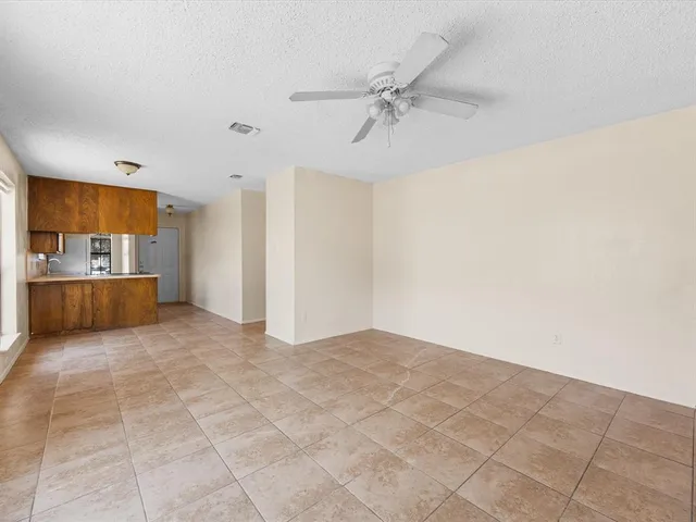 a view of a kitchen with furniture and an empty room