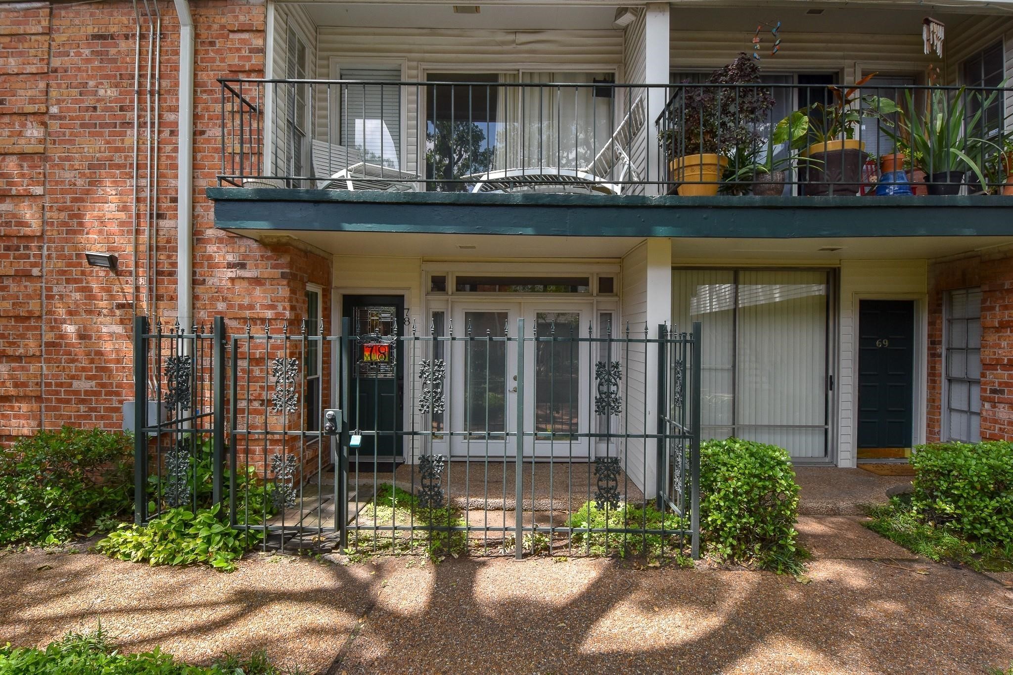 3400 Timmons Lane, Unit 78 Houston, TX 77027 - Photo 2 of 20 front view of a house with a small yard