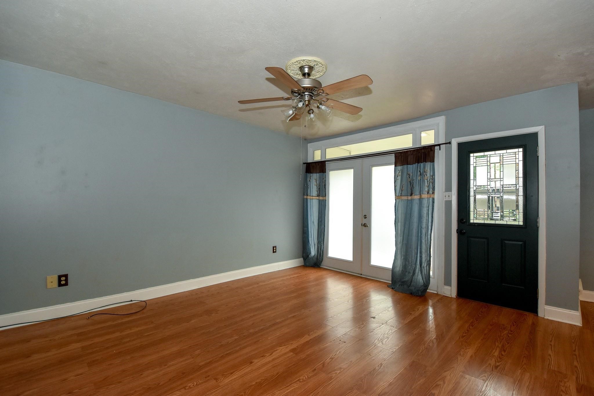 3400 Timmons Lane, Unit 78 Houston, TX 77027 - Photo 3 of 20 a view of an empty room with window and wooden floor